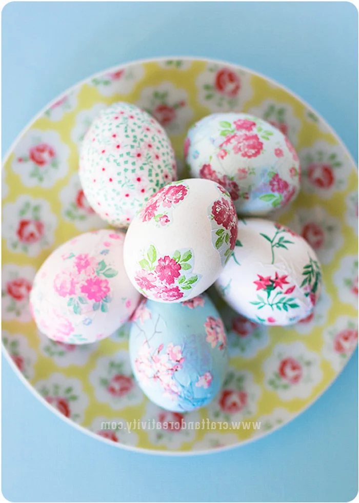 floral decoupage eggs, in a floral plate, tie dye eggs, on a blue background, colourful dyed eggs