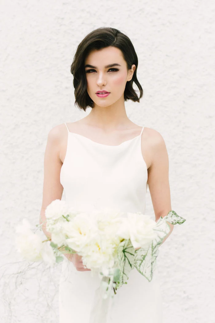 white dress, white flower bouquet, short black hair, wedding hairstyles, wavy hair