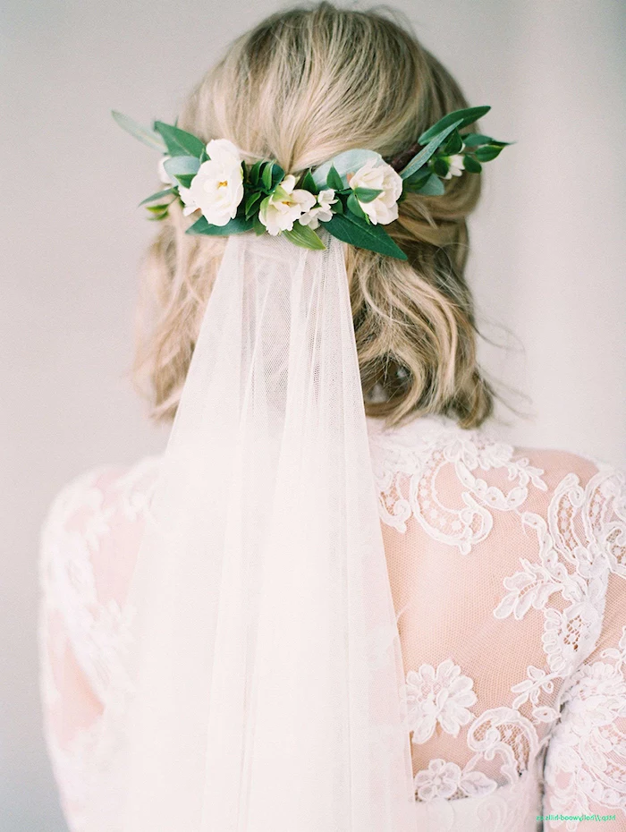 short wavy blonde hair, white veil, with a floral clip, white lace dress, wedding hairstyles for long hair