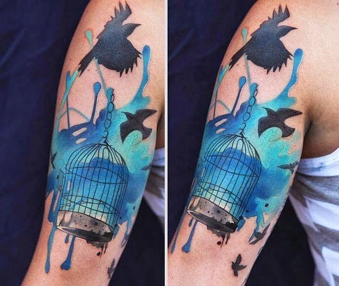 bird cage, birds flying away, watercolour shoulder tattoo, inner arm tattoos, blue background