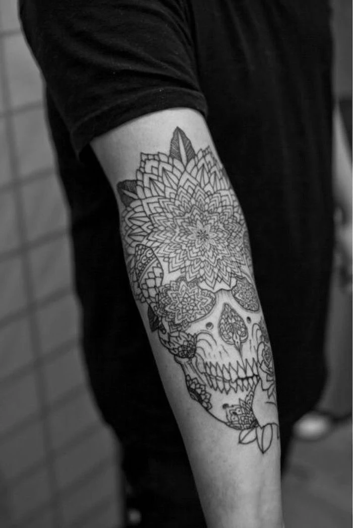 skull with flowers, forearm tattoo, tribal tattoos for men, man wearing all black, tiled wall