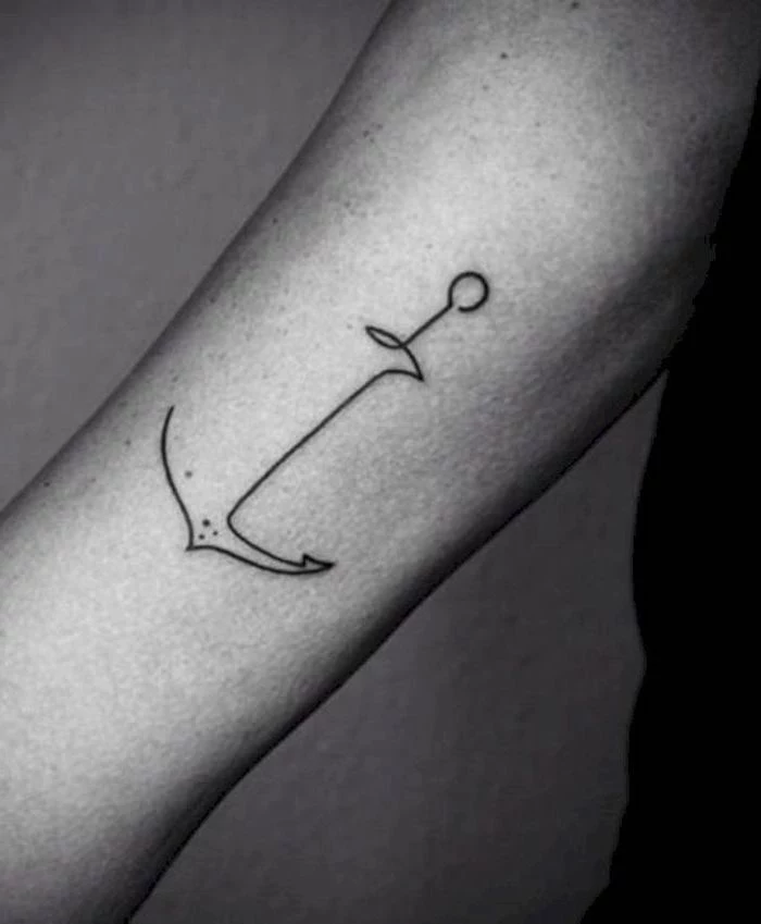 small black line anchor, forearm tattoo, tribal tattoos for men, grey background, black shirt