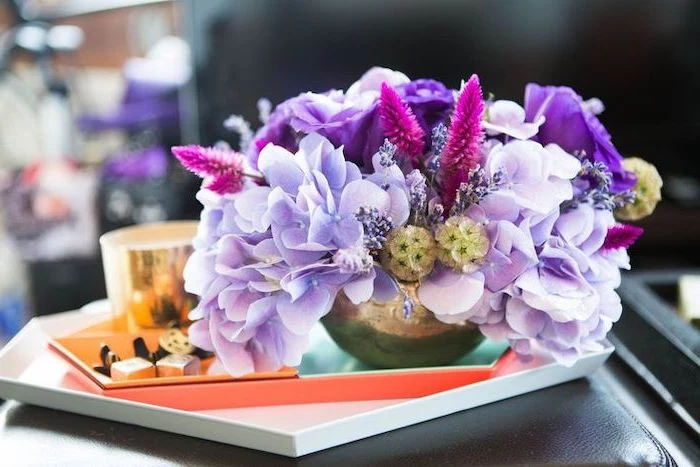 small purple flower bouquet, in a small brass vase, diy flower arrangements, on a small leather stool