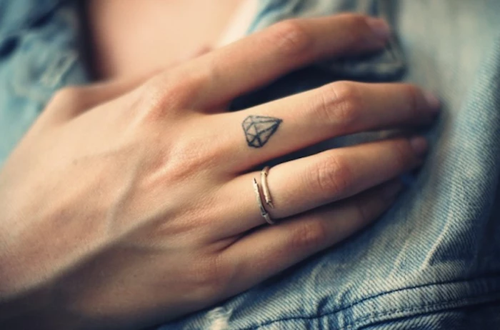 small diamond, middle finger tattoo, couple fingers tattoo, small ring on the ring finger