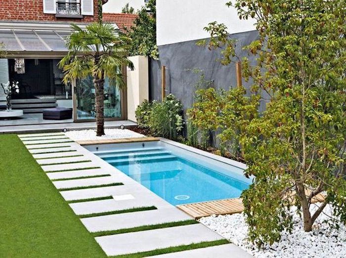 small swimming pool, small backyard patio ideas, ceramic tiles on the grass patch, planted palm trees and bushes
