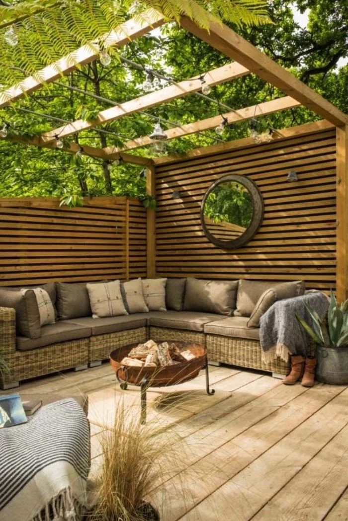wooden shed, garden furniture, with colourful throw pillows, underneath it, on a wooden floor, small yard landscaping