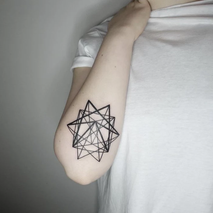 geometric tattoo, geometrical star, under the elbow, person dress in white shirt, standing in front of a white background