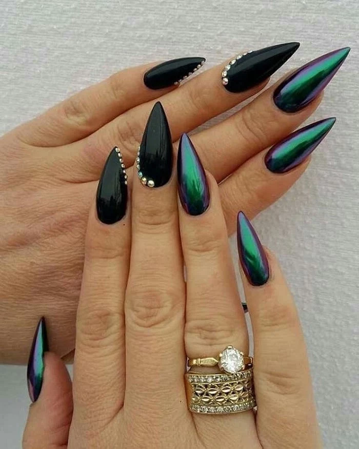 green chrome nail polish, black nail polish, trending nail colors, rhinestones on nails, golden rings