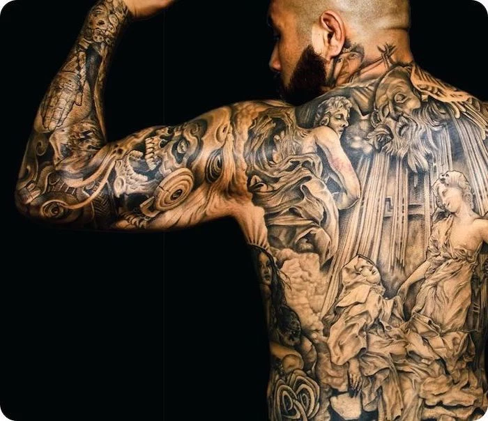 man flexing, religious theme, whole back tattoo, arm sleeve tattoo, meaningful tattoos, black background