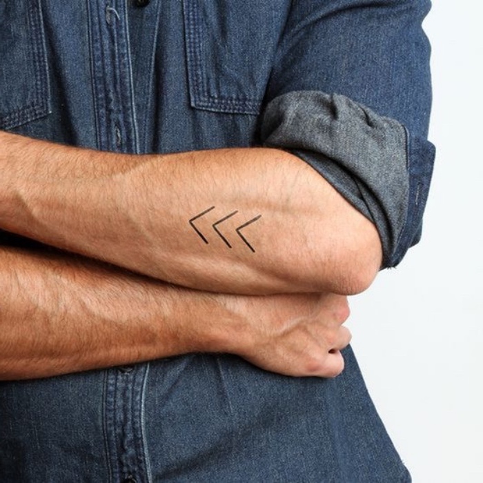three arrows forearm tattoo, man wearing a jean shirt, small tattoo ideas for women, crossed arms