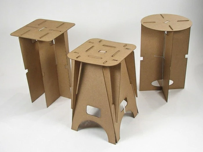 three cardboard stools, in fron of a white background, cardboard furniture