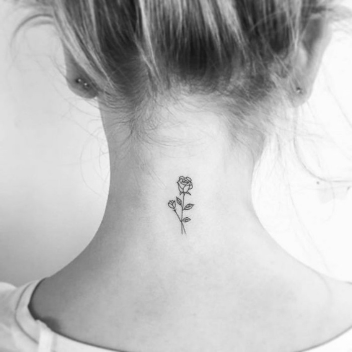 two roses back tattoo, woman with blonde hair, in a messy bun small matching tattoos