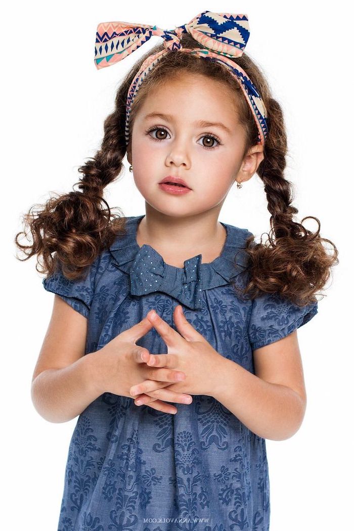 blue dress, printed bow bandana, long brown hair in two braided ponytails, french braid ponytail