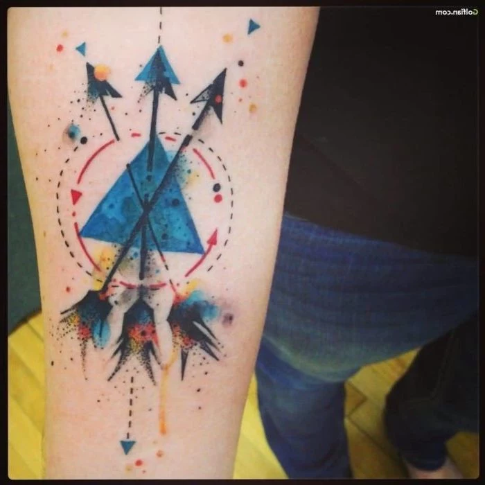 three arrows, geometrical design, watercolour forearm tattoo, tattoo ideas with meaning, man wearing jeans