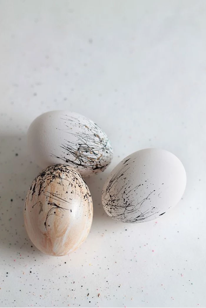 how to color eggs, white and brown eggs, black splatter on them, minimalist design, white background