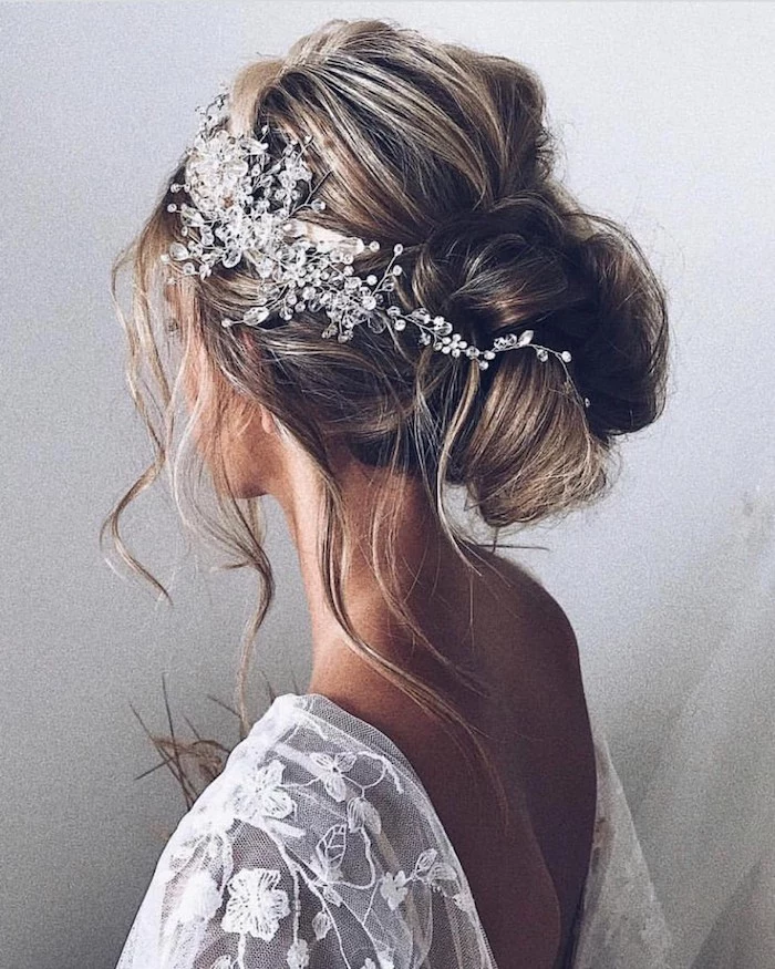 white lace dress, brown hair with highlights, in a low updo, loose updos, large pearl hair accessory