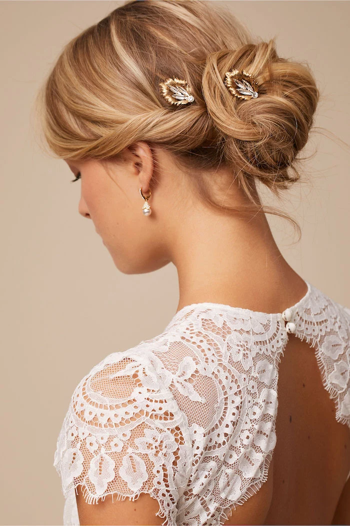 white lace dress, blonde hair in a low updo, small crystal hair accessories, loose updos