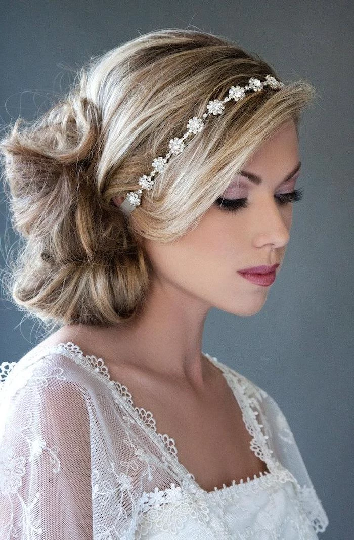 blonde hair with highlights, in a low updo, small headband, loose updos, white lace dress