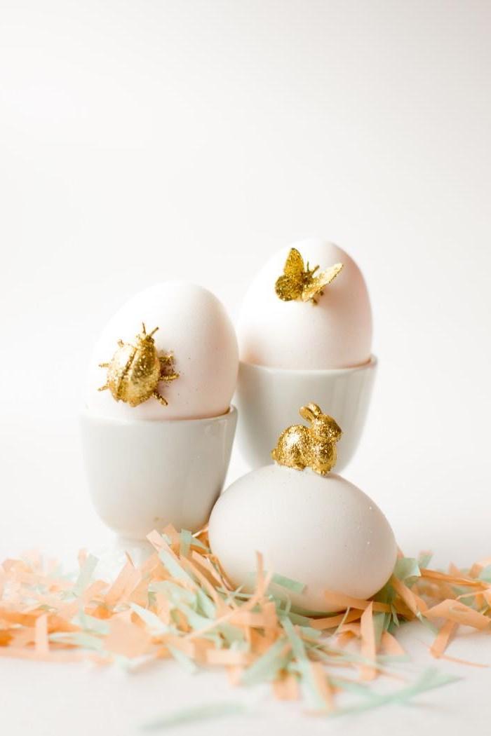 white eggs, golden figurines, glued on them, bunny butterfly and beetle, ow to color eggs, colourful confetti
