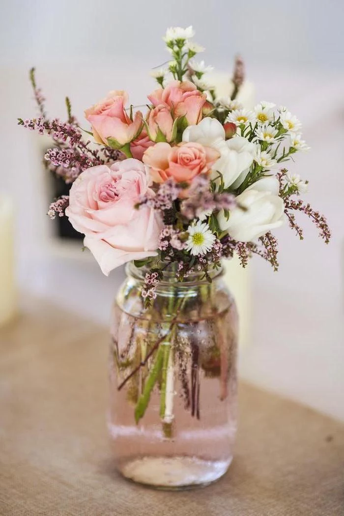 pink and white roses and tulips, small flower bouquet, flower arrangements ideas, in a small jar, on a wooden table