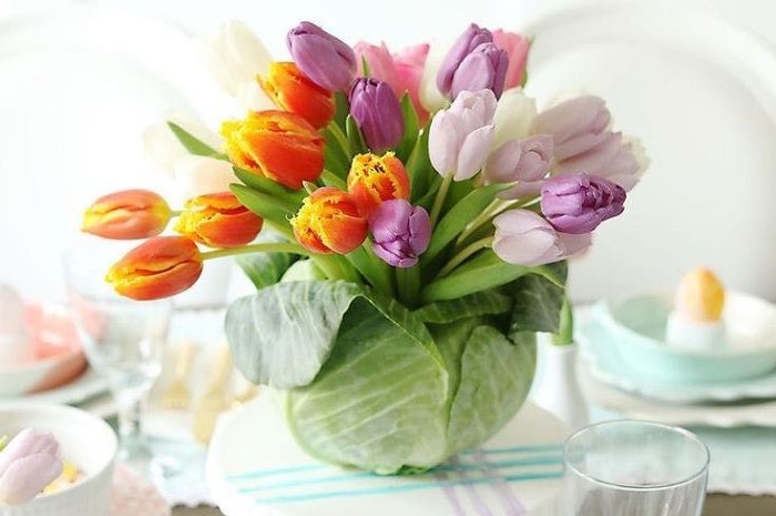 large bouquet of colourful tulips, inside a cabbage, easter decorating ideas, on a table