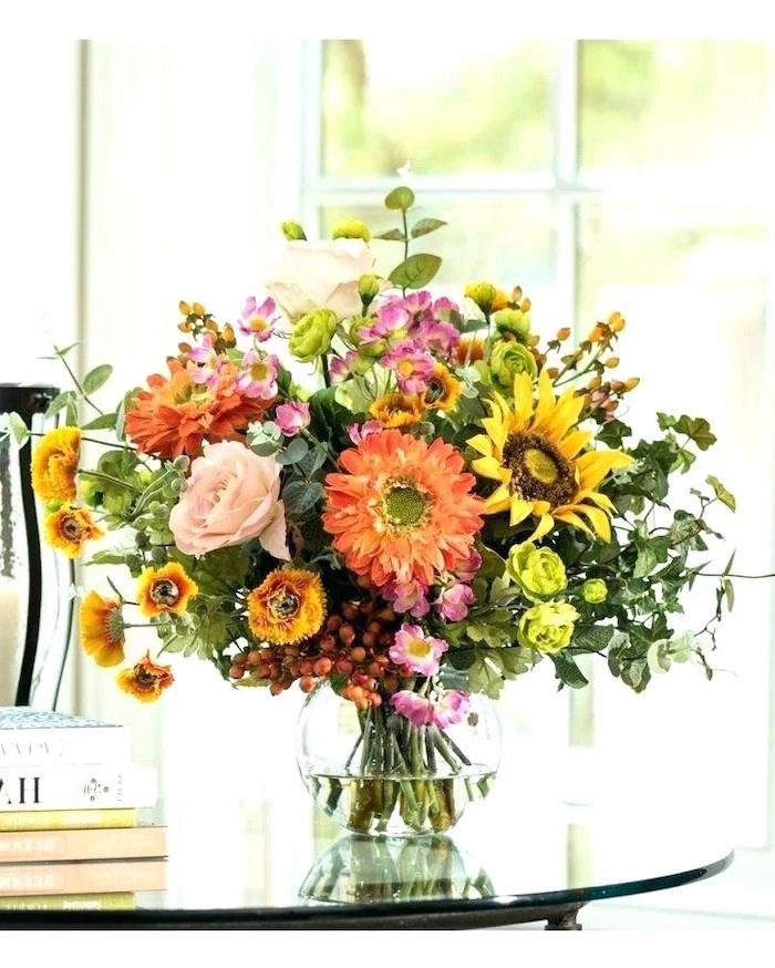 large colourful flower bouquet, in a round glass vase, on a glass table, flower arrangements ideas