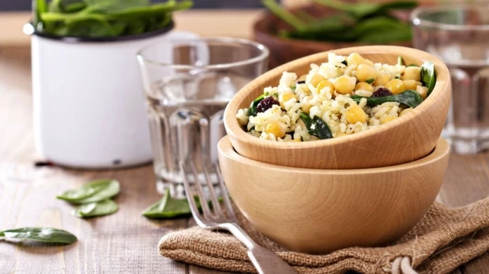 wooden bowls, full of white rice, with corn and basil, healthy meal plans for women, wooden table
