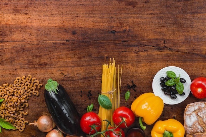 wooden countertop, healthy meal plans for women, aubergine and onions, peppers and tomatoes, olives and pasta