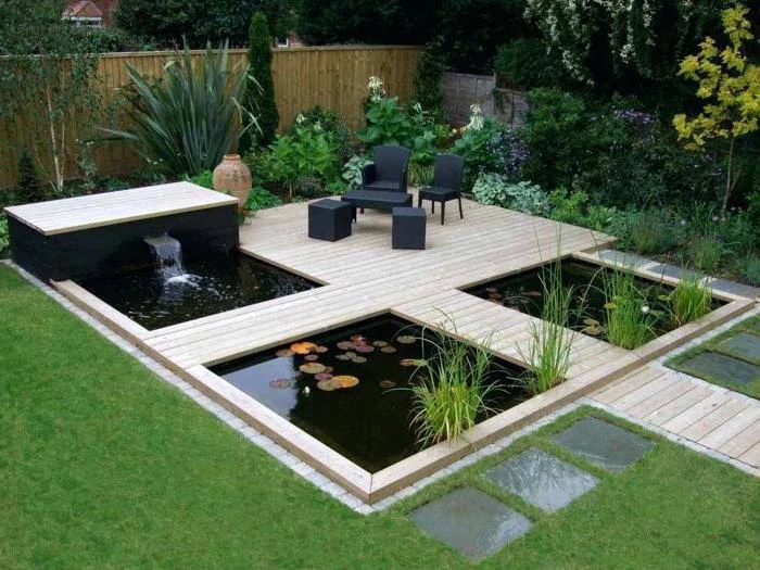 small ponds, with a small fountain, small space gardening, wooden pathways over them, planted bushes and trees