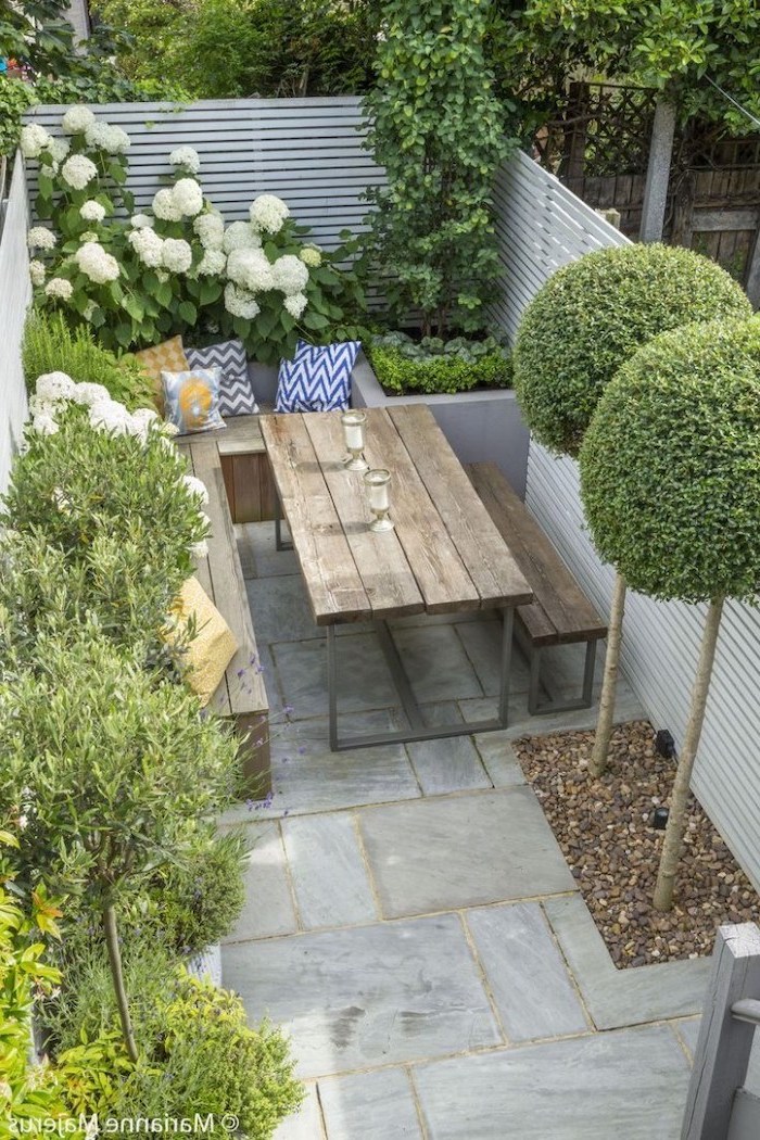 wooden garden furniture, planted trees bushes and flowers, small patio ideas, cement tiled floor