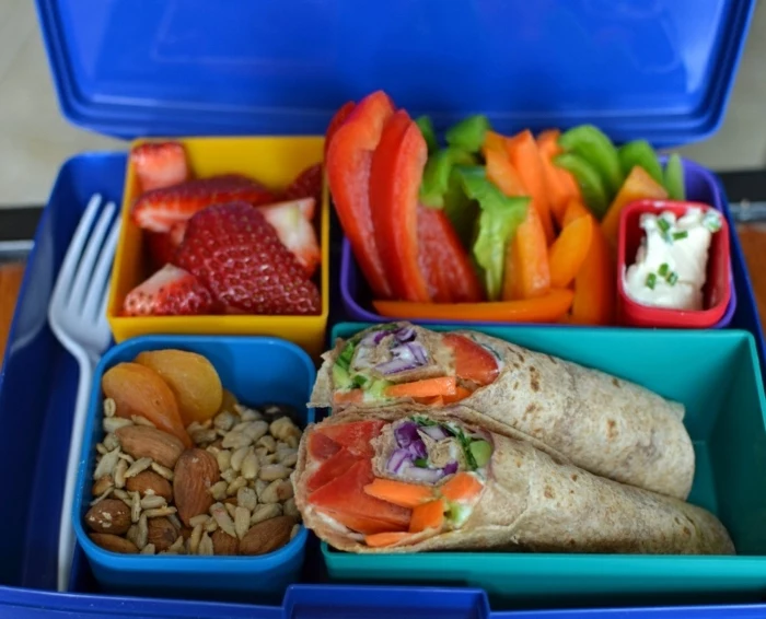 lunch box, full of peppers, strawberries and fruits, tacos with fish, what is a balanced diet