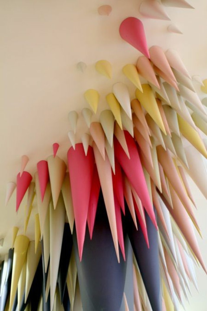paper cones, colourful paper, on a white background, living room wall ideas, small and big cones