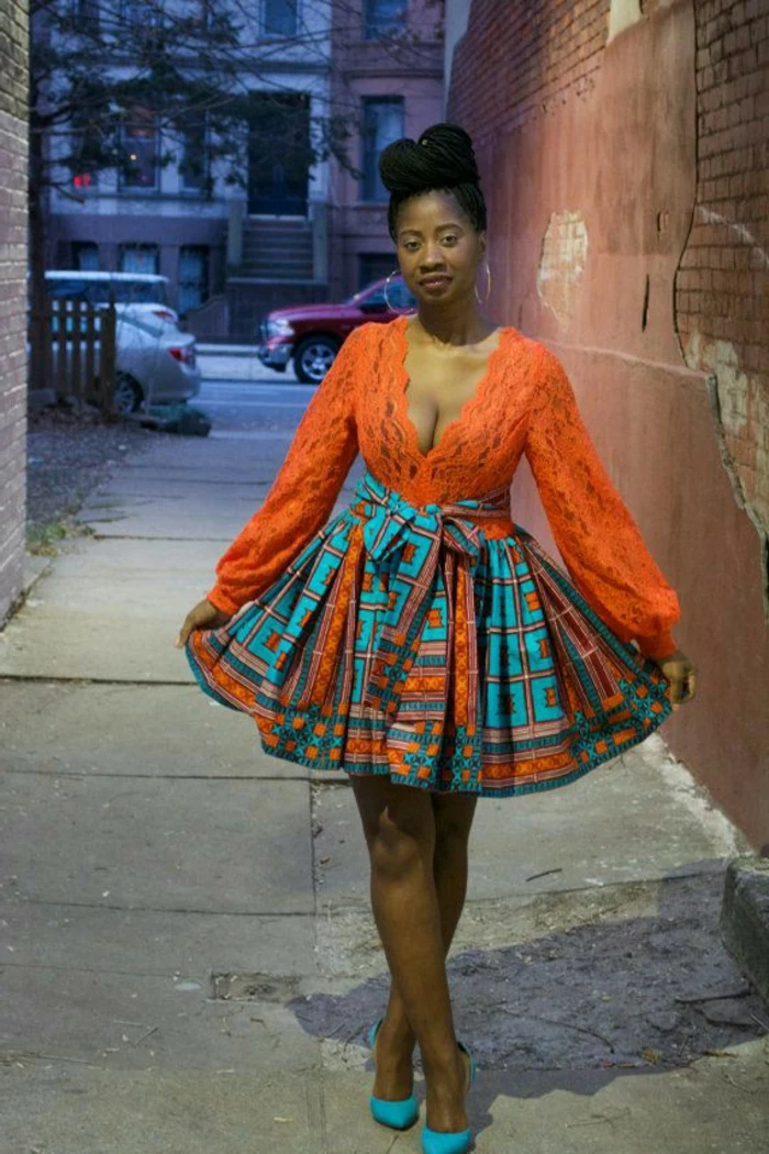 orange lace top, colourful skirt, blue heels, african print dresses, brick wall, hair in a bun