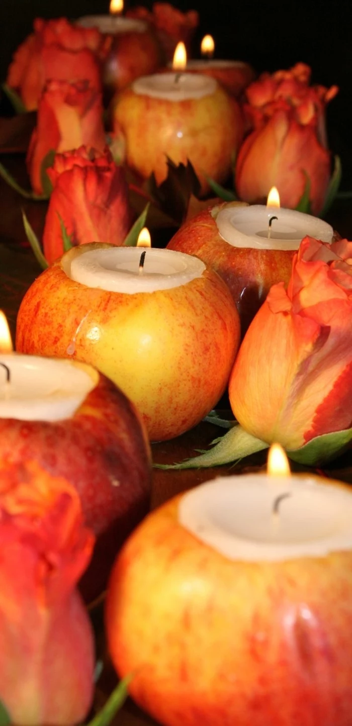 emptied apples, filled with candles, red tulips, surrounding them, table setting ideas