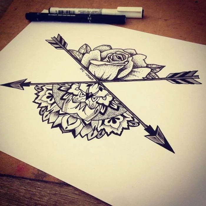 arrows crossing, half rose, mandala tattoo, black white sketch, white background, wooden table