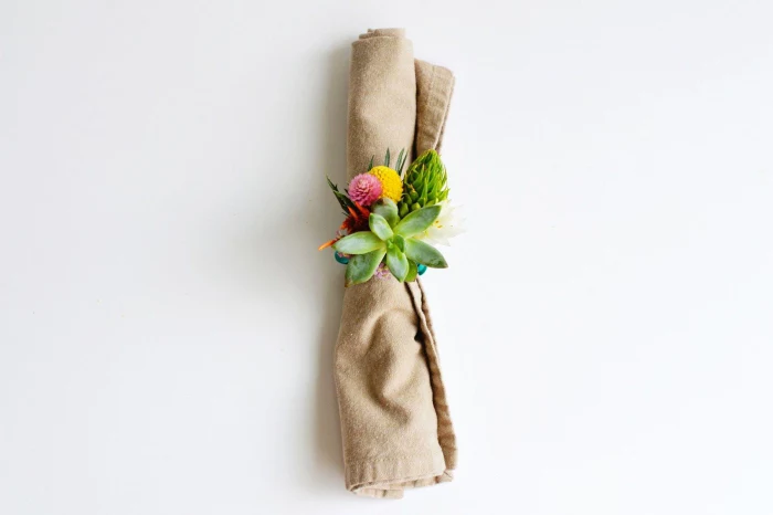 beige cotton napkin, table centerpieces, floral napkin ring, made of succulents and flowers