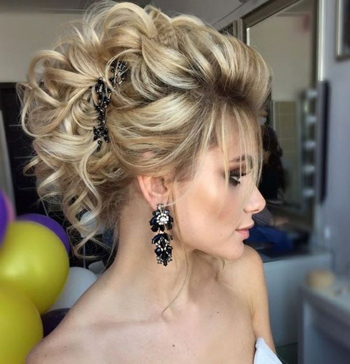 long blonde hair, in a messy updo, black hair accessory, long hairstyles for women, black hanging earrings