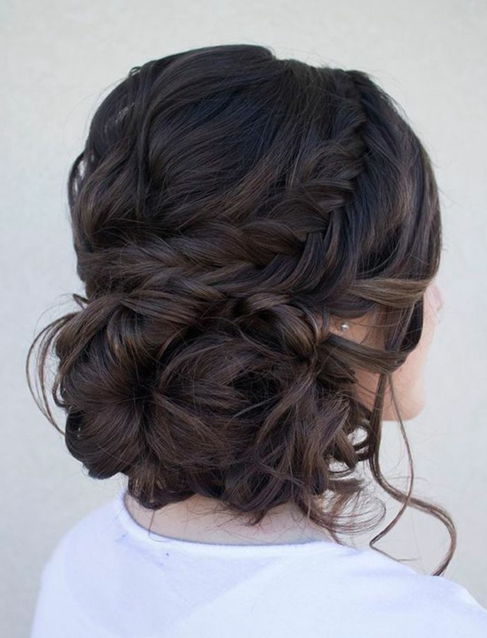 hairstyles for teenagers, black hair in a braided, low updo, woman wearing a white blouse, pearl earrings