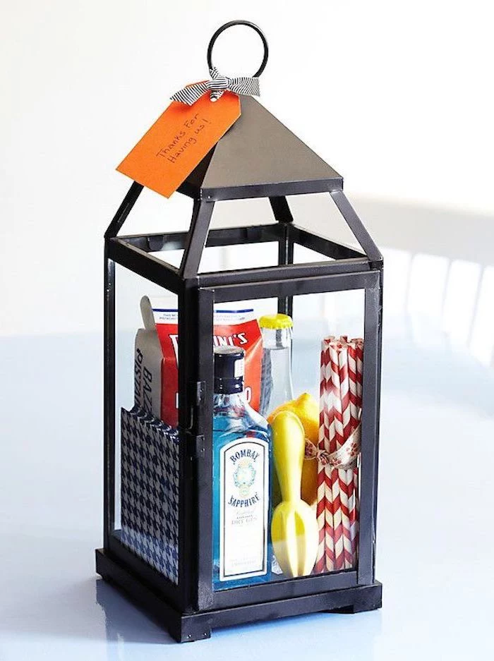 funny housewarming gifts, black metal lantern, filled with straws, gin and tonic
