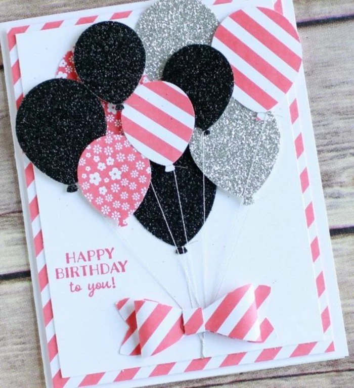 silver and black glitter, pink patterned balloons, pop up birthday cards, white card stock, wooden table