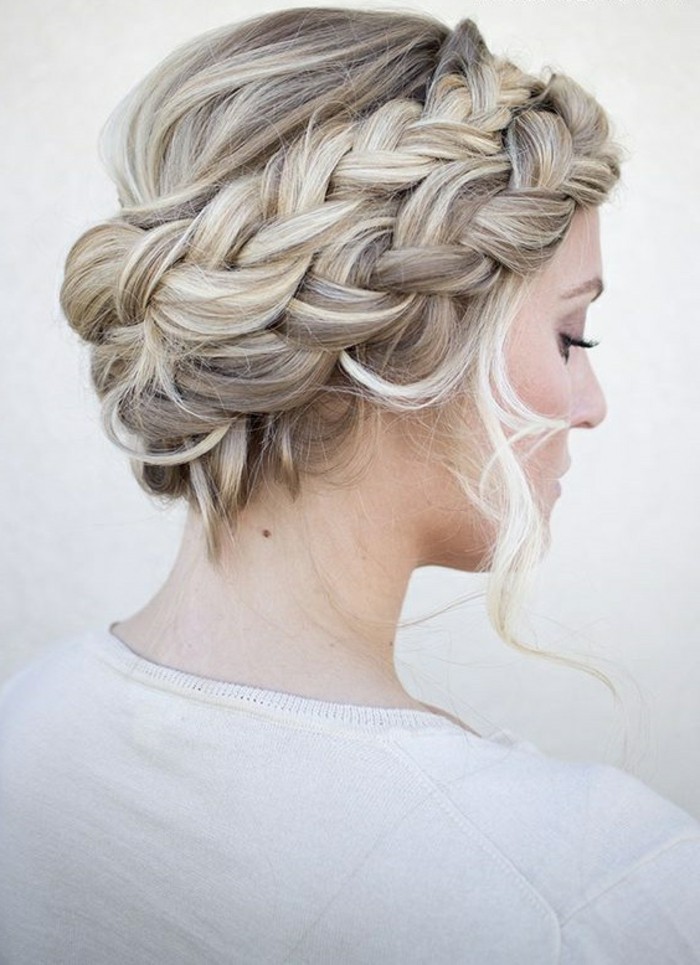 blonde hair, with highlights, in a braided low updo, easy hairstyles for short hair, woman wearing a white top