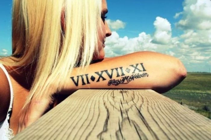 blonde hair, side arm tattoo, birthday tattoos, name and roman numerals