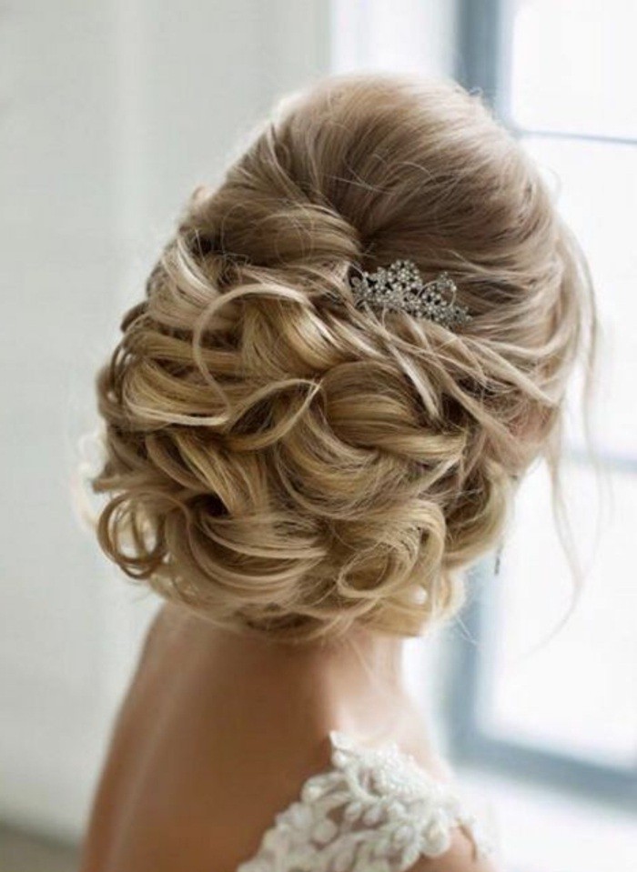 blonde hair, with highlights, in a low messy updo, hair accessory, prom hairstyles for short hair