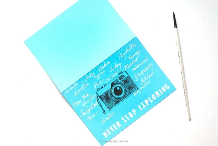 blue card stock, vintage camera, drawn on it, never stop exploring, cute birthday cards, white background