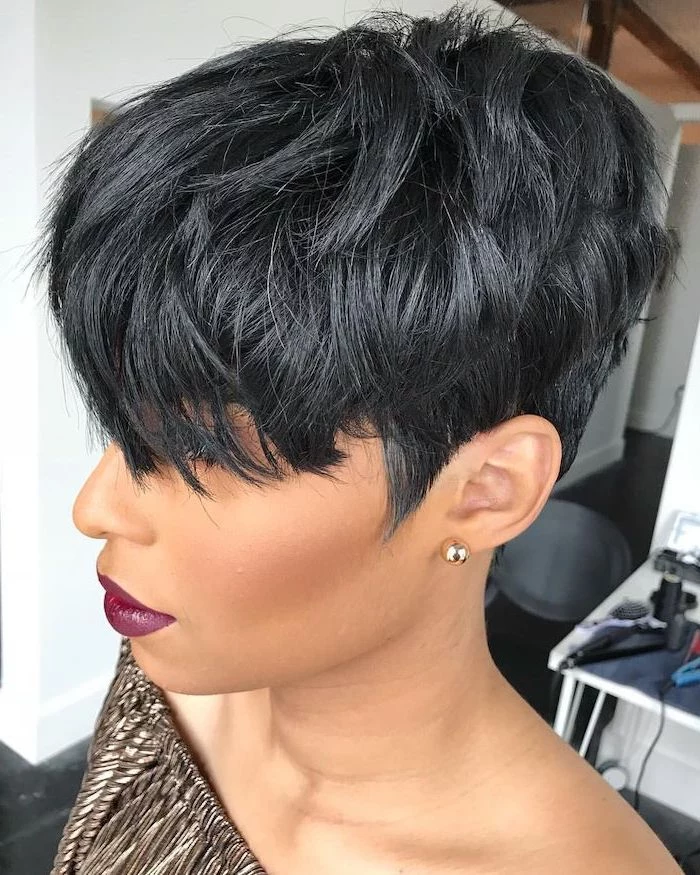 black hair, short haircuts for older women, gold pleated top, gold earrings