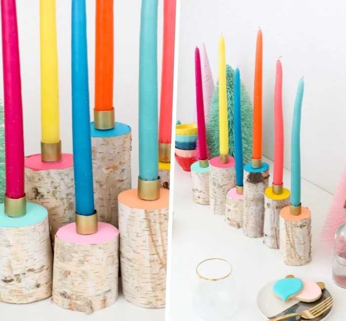 colourful candles, on top of round blocks of wood, table centerpieces, painted in different colours