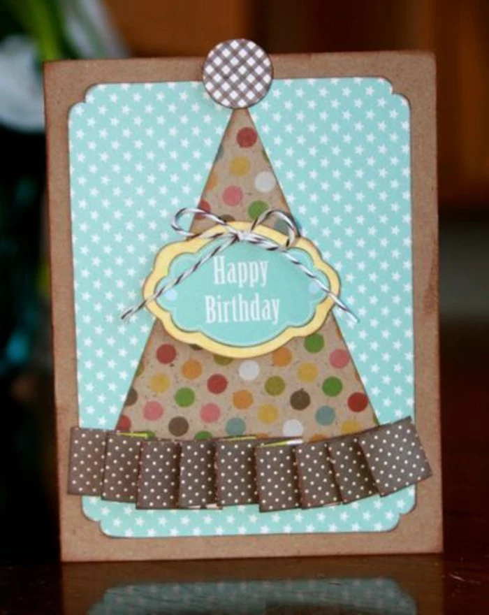 birthday card design, colourful party hat, brown ribbon, blue card stock, white stars on it
