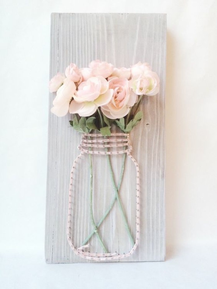 mason jar, made of pink strand and nails, faux roses inside, on a wooden block, cool art designs