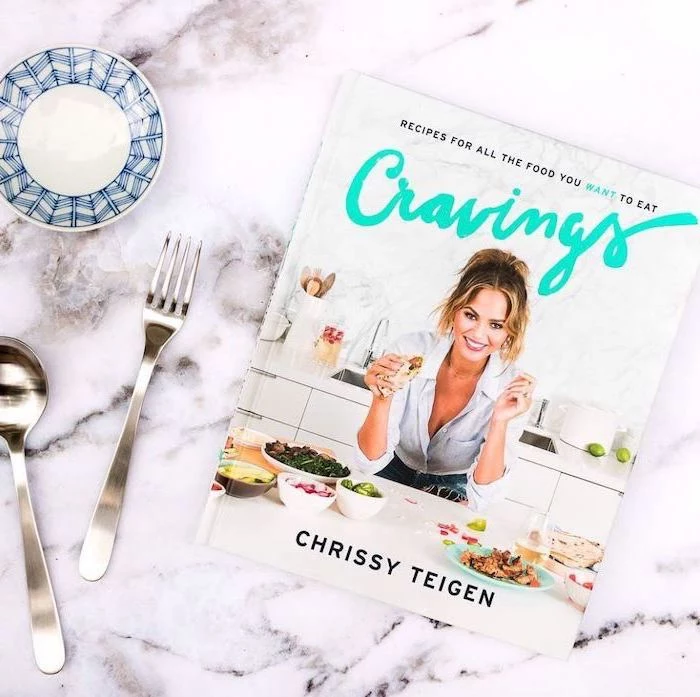 cook book, housewarming ideas, cravings by crissy teigen, on a marble countertop