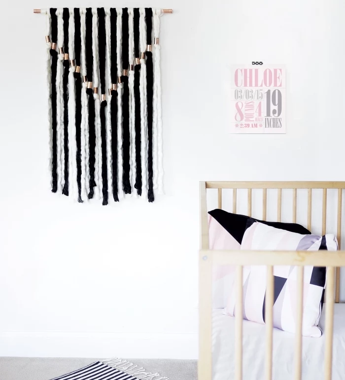 black and white macrame, wall art, hanging over a baby crib, white wall decor, colourful throw pillows
